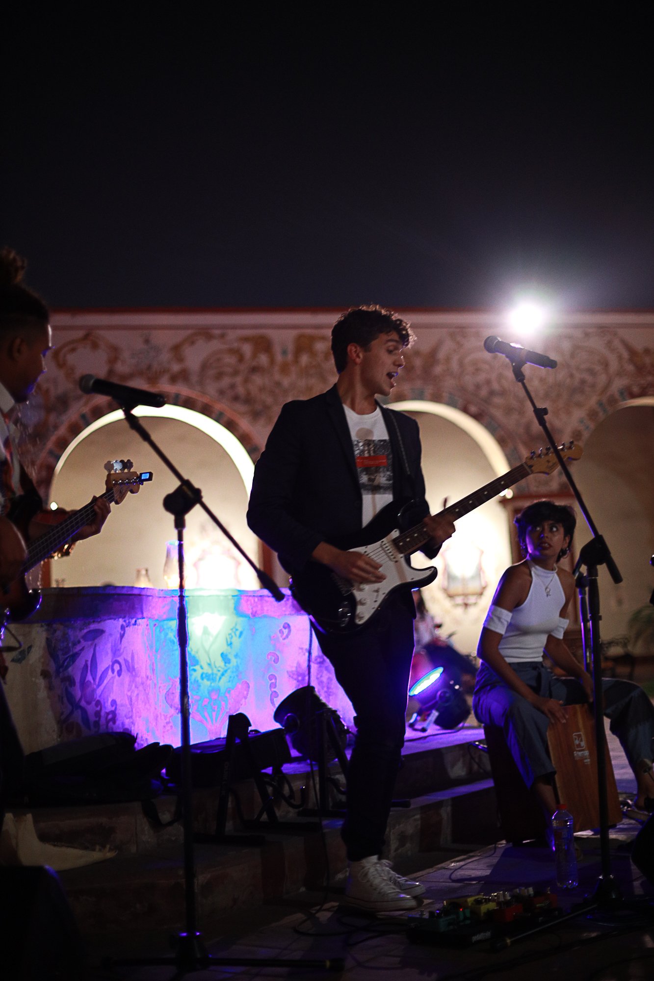 Live musician performing at an intimate private gathering at night